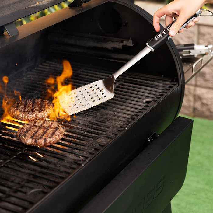 Pit Boss Spatula for grilling and smoking, flipping burgers on hot grill with flames