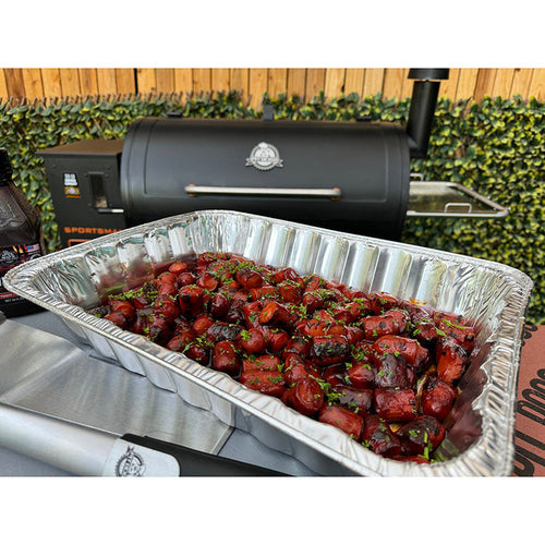Silver Pit Boss Grills all-purpose foil pans filled with grilled food, perfect for cooking and serving.