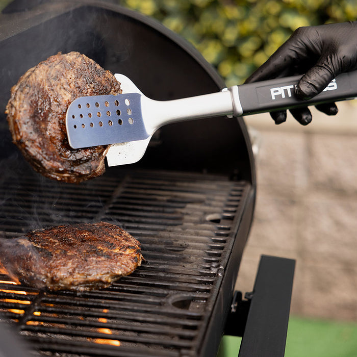 Pit Boss All In One BBQ Tool, flipping burgers cooking on wood pellet grill with gloved hand
