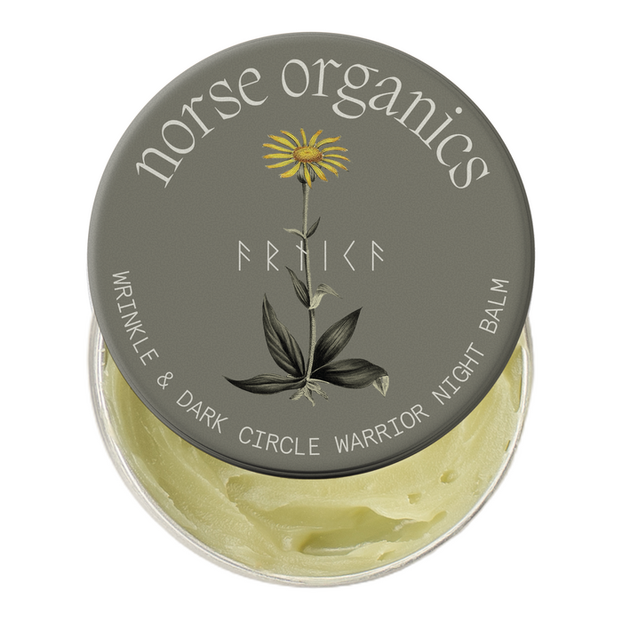 Wrinkle & Dark Circle Warrior Night Balm tin with arnica botanical lid art and yellow natural balm