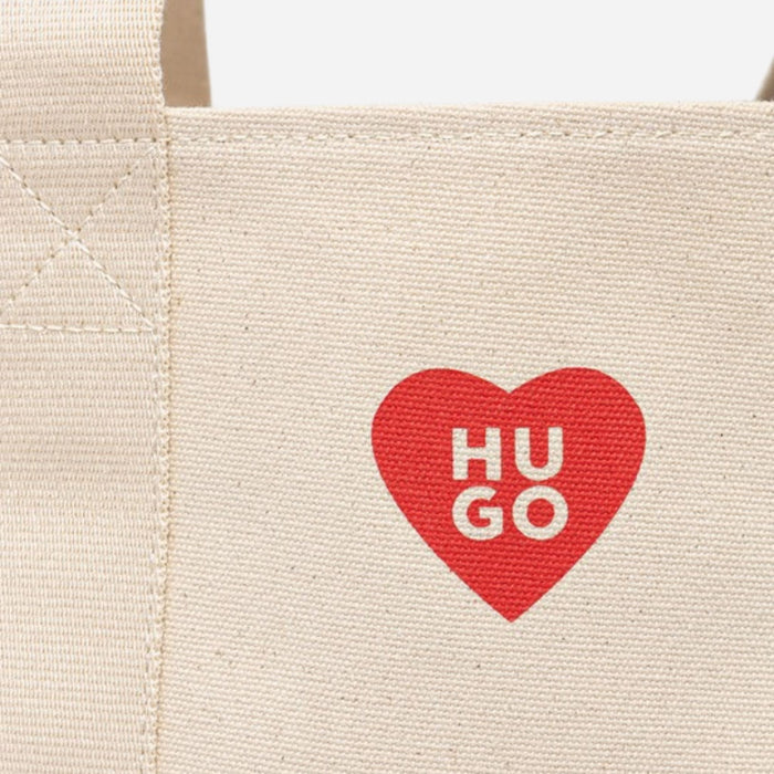 Close up of the Hugo Boss logo and red heart on the BOSS Becky Beige Tote with Hugo Heart Logo.