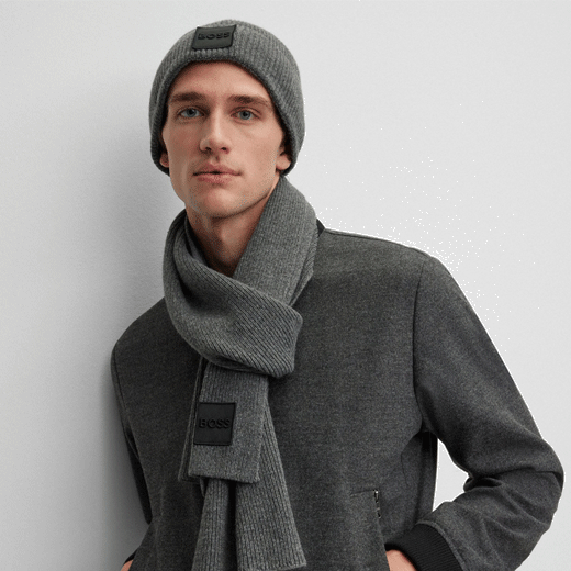 This BOSS Grey Metaverse Knit Beanie Hat and Scarf Set has a patch on both items with the brand name embroidered.
