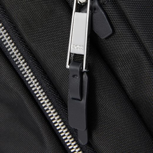 This BOSS Highway Black Nylon & Leather Trim Roll Top Backpack has two raised front pockets along with the main compartment and the space for your laptop.