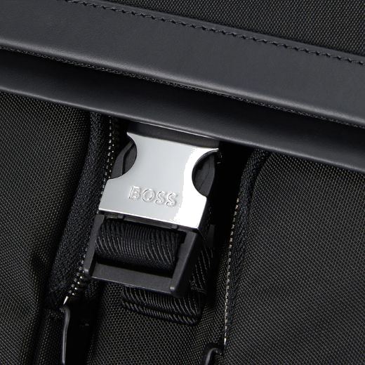 You'll find a clasp closure that opens up the folded top into the main compartment.
