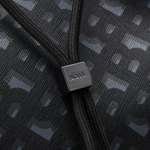 This Icon Monogram Print Faux Leather Backpack by BOSS has a drawstring closure underneath the flap so you can rest assured that your belongings are safe.