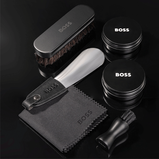 This Iconic Black Shoe Care Kit by Hugo Boss comes in a presentation box and includes a shoe horn, shoe polish, two brushes and a cloth for cleaning.