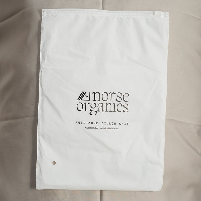 Norse Organics anti-acne pillowcase in its white drawstring bag, made from anti-microbial bamboo