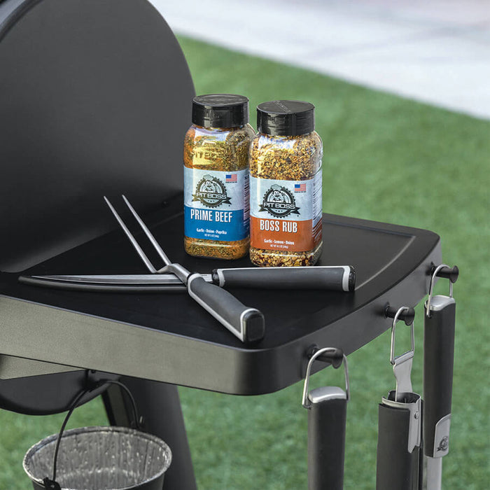 Black Pit Boss Grills Fixed Side Shelf Upgrade with seasoning bottles and tools, perfect for grilling essentials.