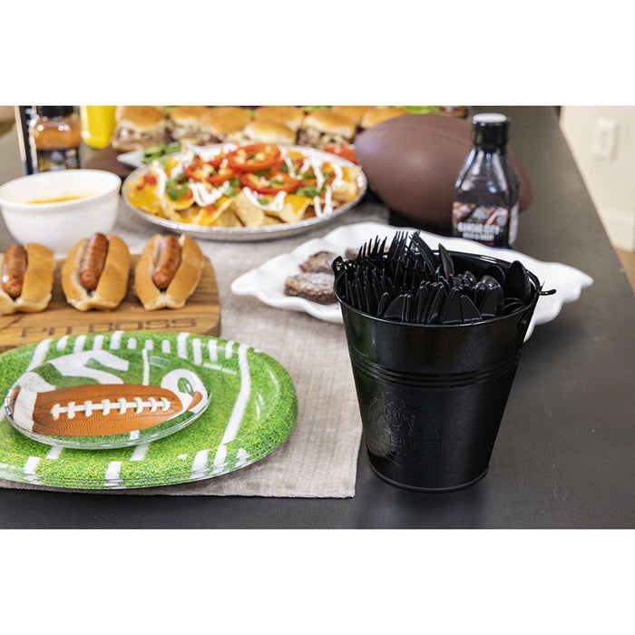 Bucket being used with utensils in it. Displayed on table.