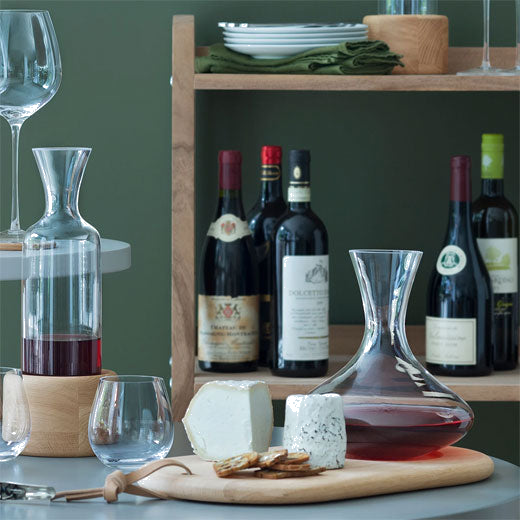 LSA's Signature Wine Carafe & Oak Cheese Board features a natural leather handle.