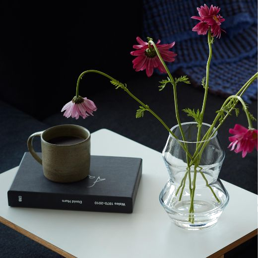 This Small Sculpt Glass Vase 16 cm by LSA is made with mouth blown glass with a sturdy exterior.