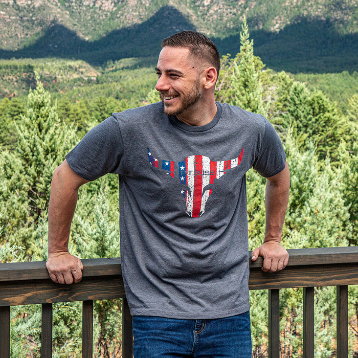 Gray Pit Boss Grills Men’s Heather American Bull T-Shirt with red, white, and blue bull graphic, worn outdoors.