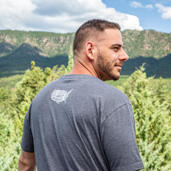 Gray Pit Boss Grills Men’s Heather American Bull T-Shirt with bull logo on back, outdoors.