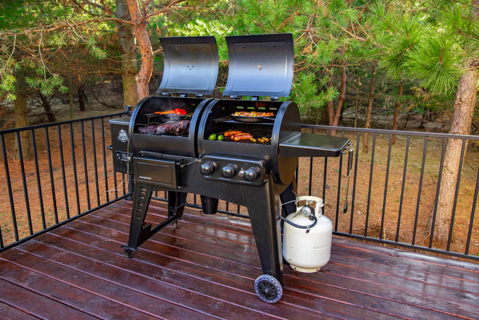 Front shelf hanging on all black pit boss grill. Grill outside on a deck.