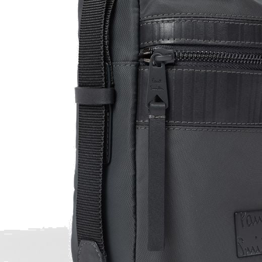 This Men's Slate Grey 'Shadow Stripe' Trim Flight Bag has a small patch on the front with the Paul Smith name embossed.