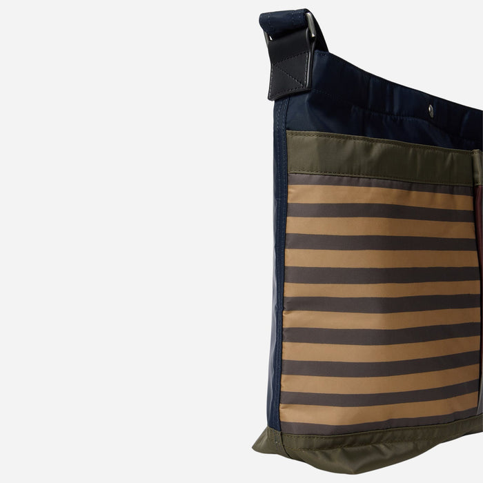 Side view of the Paul Smith Multistripe Recycled Nylon Adjustable Tote Bag with Signature Logo Patch.