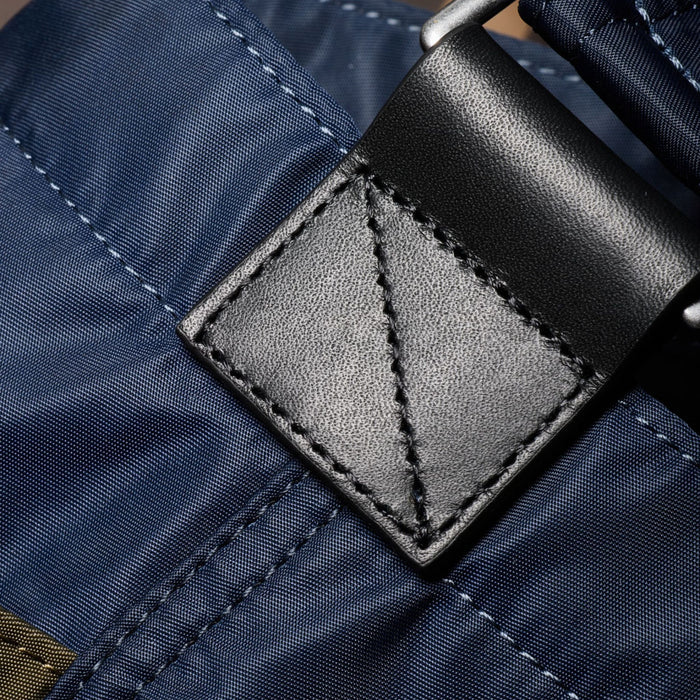 Black leather trims on the Paul Smith Multistripe Recycled Nylon Adjustable Tote Bag with Signature Logo Patch.