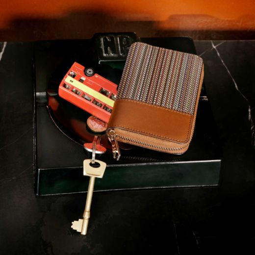 This Signature Stripe Coated Canvas Zip-Around Purse is compact yet has enough card slots to keep you organised.