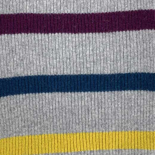 This Paul Smith grey scarf comes with two grey faux fur baubles on both ends.