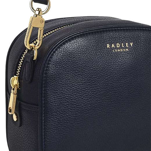 This Radley Arden Crescent Ink Leather Cross Body Bag has polished gold trims including the zip, lobster clasp and the gold foil embossing with the brand name.