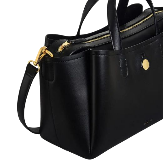 The polished gold trims of the Bathurst Mews Black Medium Ziptop Grab Bag match the smooth black leather.