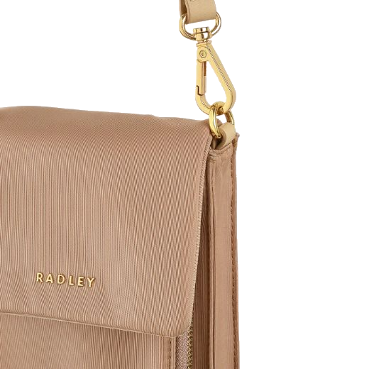 The Guildford Grove Medium Stone Phone Cross Body Bag closes with a magnetic fastening flap, and shows the Radley logo in gold metal letters on the front.