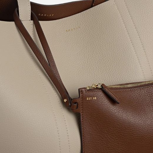 The zipped leather pouch of the Hanbury Row Chocolate Brown Large Reversible Open Top Tote Bag.