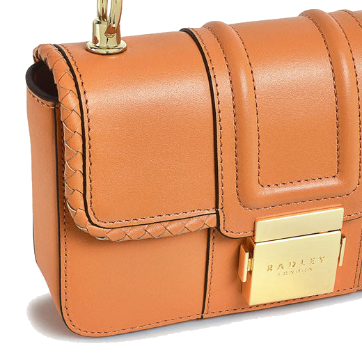 This Hanley Close Apricot Mini Flap Over Bag by Radley has a front lock clasp in gold hardware with the Radley brand name engraved.