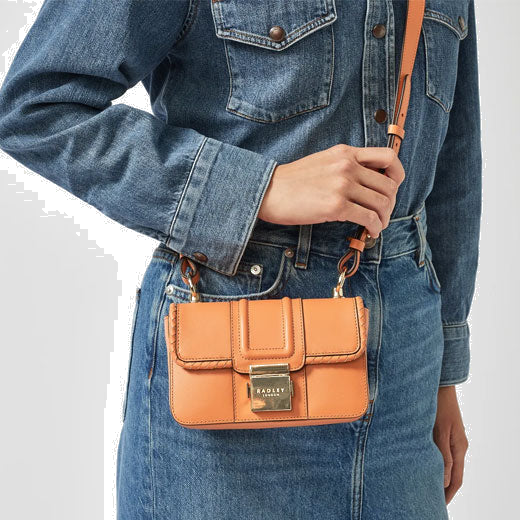 Radley's Hanley Close Apricot Mini Flap Over Bag can be worn as a crossbody bag and is adjustable to suit your desired length.