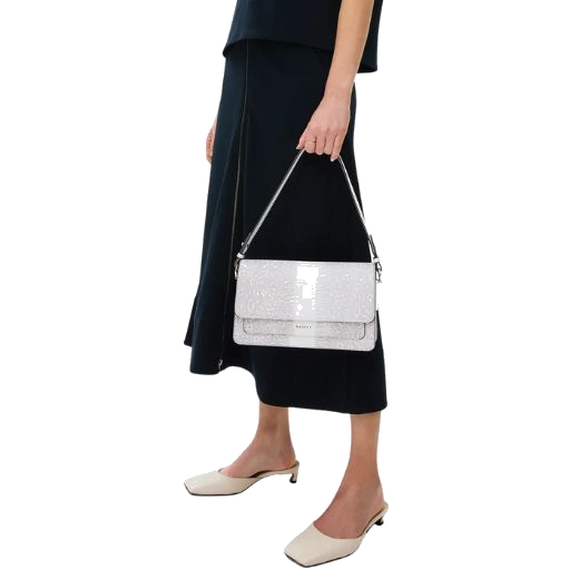 In addition to the shoulder strap, the Leather Lane Bright White Faux Lizard Medium Flapover Shoulder Bag comes with a detachable cross body strap for a more casual look.