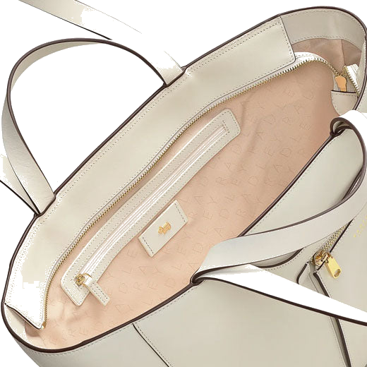 The interior of this Radley Pockets Icon Light Natural Tote Bag, Large has a sand-coloured branded lining with a small zipped pocket.