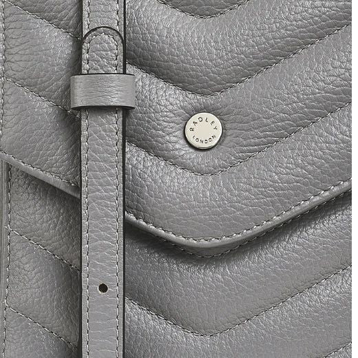 These is a matching grained leather adjustable cross body strap on this Radley Rowe Avenue Quilted Grey Phone Cross Body Bag.