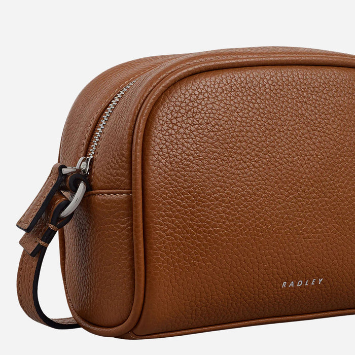 Side view of the Radley The Daily Toffee Brown Small Zip Top Cross Body Bag.