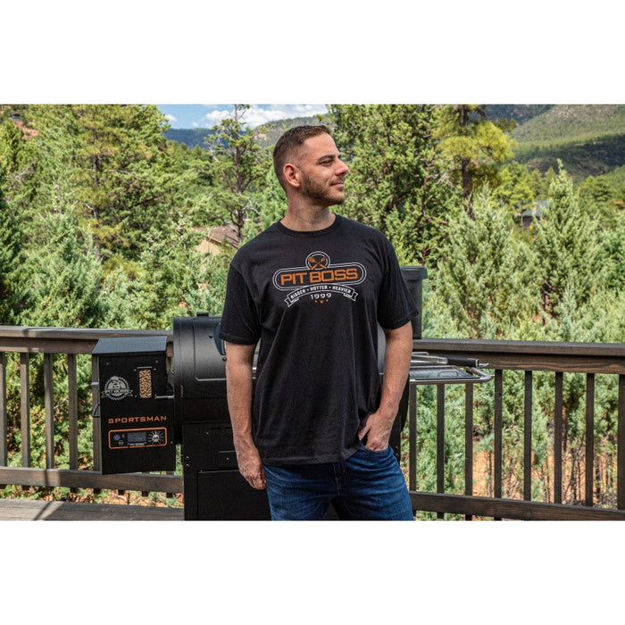 Black Pit Boss Grills "Tools of the Trade" men's charcoal heather t-shirt, worn outdoors near a grill.