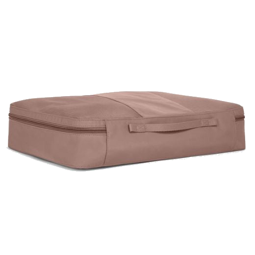 TUMI's Large Packing Cube in Light Mauve has a thin grab handle on one side.