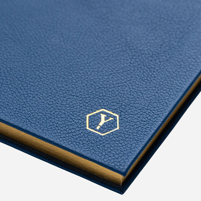The Yard-O-Led logo embossed in gold foil on the front of the Yard-O-Led Sampson A5 Luxury Navy Blue Leather Notebook.