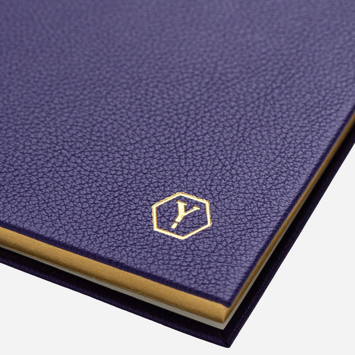 The Yard-O-Led logo embossed in gold foil on the front of the Yard-O-Led Sampson A5 Luxury Purple Leather Notebook.